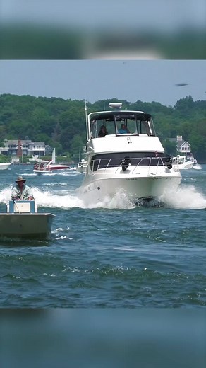 Large Silverton Vessel Overtakes Small Boat at Canal