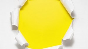 Paper sheets tearing from the center opening the screen transition. Stop motion animation.