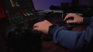 Download Asian creator editing production work in neon-lit office. for free