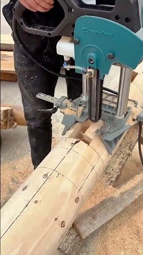 Cutting precise mortises on a log using a specialized chain mortising machine for woodworking