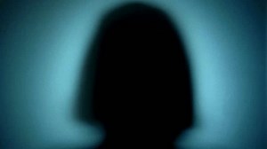 spooky ghost hand waving and scratching hands behind the frosted glass. A woman's finger sliding on a glass surface. halloween mystic scary concept