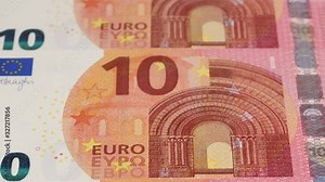 10 Euro notes close up tracking. Euro currency cash background. Slider shot, low angle. 4K