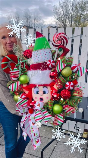 Handmade deluxe wreath featuring a giant elf head in vibrant red and green — complete with cheeky red hair and the cutest little snowflake sitting right on its nose! | Wreaths and Ribbons | Facebook