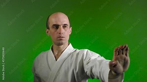 On a color-changing background, an adult athlete throws punches