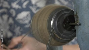 Rotating spindle in a manual woolen lock during operation. Extra close-up hand-operated spindle parts in action. Stock Video