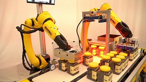 See it live at PACK EXPO Las Vegas, booth C-1651! Two robots - Including the new FANUC M-20iD/25 - Pick & pack jars of candy from conveyors in a 2x3 pattern. This repetitive job is great for our highly reliable and accurate robots. Learn more at https://www.fanucamerica.com/packaging | FANUC America Corporation
