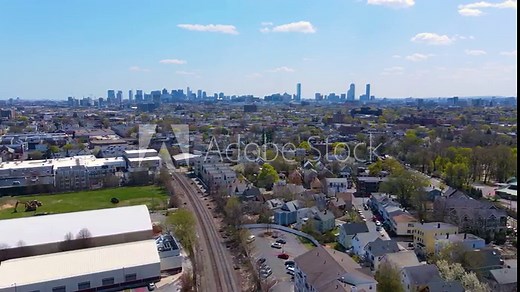 Somerville city center aerial view on Somerville Avenue with Boston skyline at the background in spring, city of Somerville, Massachusetts MA, USA.