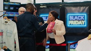 Impatient shoppers waiting in line for black friday big sales, pushing security guard and breaking into clothing store to get best deals. Obsessed customers forcing to enter shopping center.