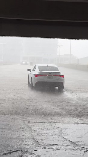 Modern Sedan Driving Through Intense Rainstorm