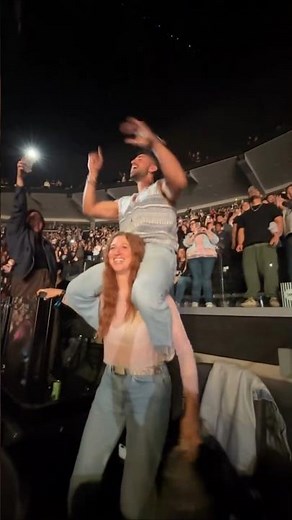 Strong girlfriend gives a shoulder ride to her boyfriend at a concert. #lift #concert #liftchallenge