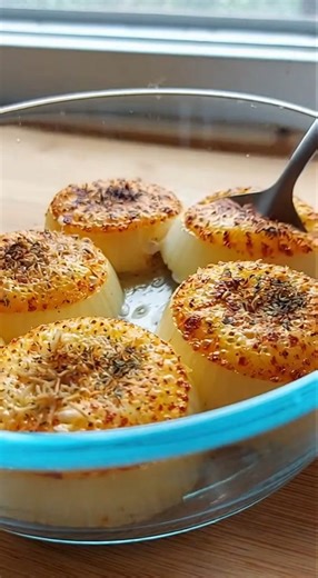 Simple, golden, and full of savory flavor, this oven-baked onion dish transforms thick slices into tender, caramelized rounds topped with crisp Parmesan. A reliable side that pairs beautifully with almost any main course. Ingredients: 3 large onions, sliced into thick rounds 40 ml olive oil 80 g grated Parmesan cheese 5 g dried oregano 2 g salt 1 g black pepper Equipment: Oven Baking sheet Parchment paper (optional) Instructions: Preheat your oven to 200°C (400°F). Arrange the onion slices in a 