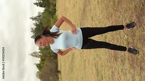 Vertical View Of An Active Woman Doing Some Hip Movements. Full Body Shot