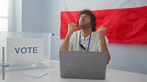 Young hispanic man using computer and headphones, angry and mad, screaming and furious in frustration - polish electoral college