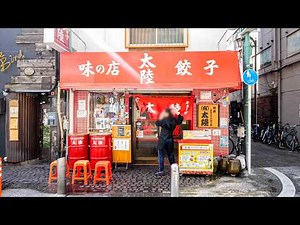 A local Chinese restaurant where the proprietress handles large numbers of orders.