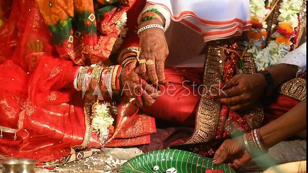 Hands of the bride and groom in wedding Ceremony. Hindu wedding ritual. Odia Wedding. Hindu Wedding Ceremony with Burning Fire and Offering Ritual with People and Golden Details.