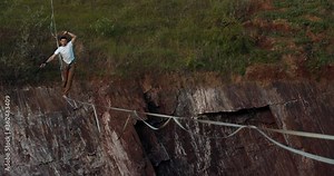 Slackliner is walking on the rope, balancing, extreme sports, 4k