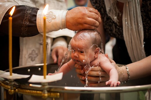 Video: Priest Injures Baby While Violently Plunging Him Into Water During Baptism | Al Bawaba