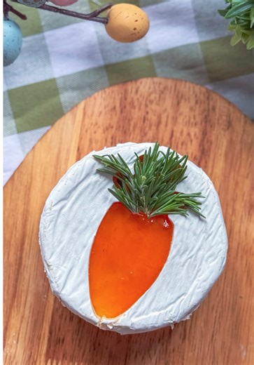 Carrot Patch Brie 🥕🧀 The easiest little spring upgrade for your cheeseboard! Using a handheld cheese slicer or a sharp knife, carefully slice the top rind off a round of Brie. Spread a layer of apricot jam on the inside, then use a carrot-shaped cookie cutter to cut a shape from the top rind you removed. Place the carrot cut-out back on top of the jam so the color shows through. Finish with a few fresh rosemary sprigs at the top to create the carrot “stem.” Simple, festive, and perfect for Eas