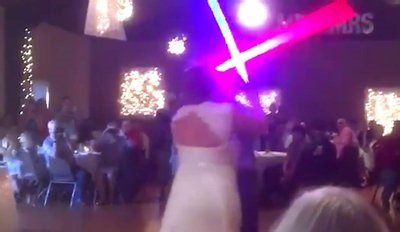Newlyweds trade first dance for bizarre lightsaber duel
