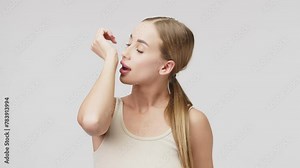 Young woman with natural face makeup on a white background with an aerosol in her hands. Natural cosmetics, spa treatments. Advertising of perfumes.