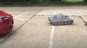 Watch This Tiny Tank Tug And Tow A Tesla Model 3