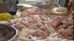 Pieces of dissected chicken is selling in farmer market. Preparing chicken meat by vendor in local morning market.