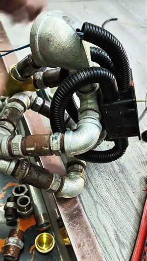 Drill a hole in the main iron pipe using a drill, then attach the power cable #machineworks #shorts