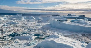 Iceberg aerial footage - giant icebergs in Disko Bay on greenland floating in Ilulissat icefjord from melting glacier Sermeq Kujalleq Glacier, aka Jakobhavns Glacier. Global warming and climate change