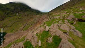 FPV Aerial view of snowdon summit in the distance covered in fog leading into diving the peak of snowdon down to the bottom