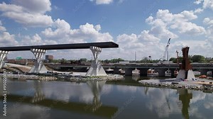 Drone aerial of new highway and multi land interstate construction coming soon and being built next to downtown and city center of Columbus, Ohio with turnpike car traffic and workers near buildings