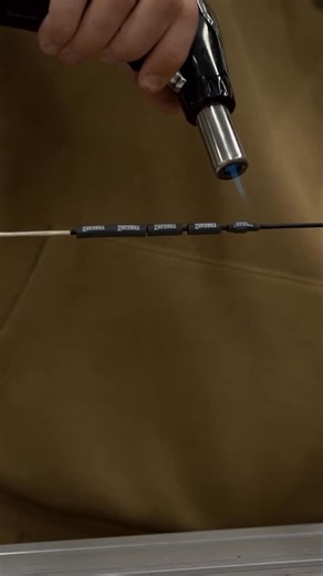 @threadzcustombowstrings on Instagram: "Where it all comes together 🔥 Steady and continuous motions, with the flame, shrinks the wrap evenly while leaving the fibers of the string untouched 👌🏼"