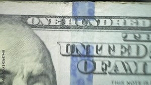 Closeup currency counting machine counting dollar. Slow motion of cash counting machine counts 100 dollar bills USD banknotes. Cash bill counter money machine. Finance banking credit deposit cash.