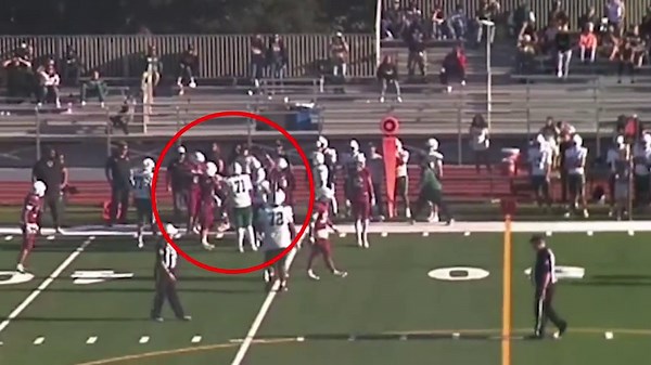 Moment football player's dad storms field and tackles opponent