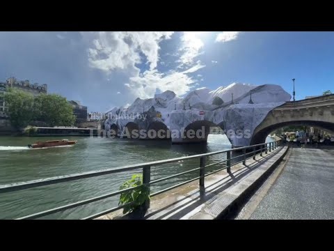French artist JR's giant 'cave' installation over Paris' oldest bridge appears damaged