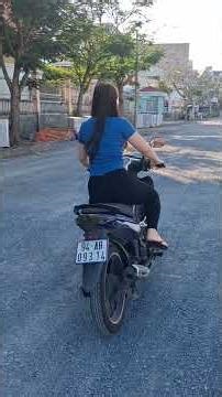 Pretty girl kicks the starter pedal on her Espero scooter.