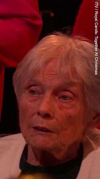 Moment Kate and Sophie share a smile as they sing carols at service