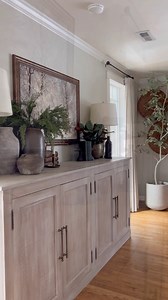 🤍Collected & Cozy European Sideboard 🤍for this sideboard styling I mixed old and new for a collected and cozy look. Let’s break it down. we built this aside board when we first moved into our house to fit this space perfectly and create a whole lot of extra storage. The pottery is a mix of new and old (there’s an antique French piece in there, a DIY, earthenware that smells like earth, enter vinyl look a new gold vase). I used cedar winter greenery to honor the season and added magnolia leaves