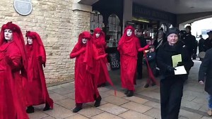 Extinction Rebellion Red Rebels protested today in Witney. Their striking white painted faces and bold red costumes caught the attention of shoppers. | Oxford Mail