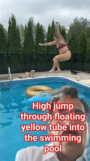 high jump through floating yellow tube into the swimming pool