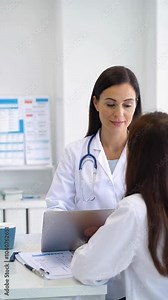 Female doctor consulting with a young girl in a medical office