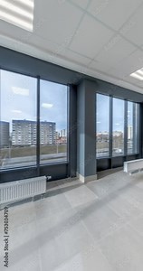 vertical loop rotation and 360 panoramic view in empty modern hall with columns, doors and panoramic windows overlooking the city.