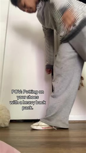 Struggling with a Heavy Backpack at School