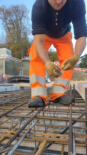 Expert Construction Worker Aligns Rebar Grid