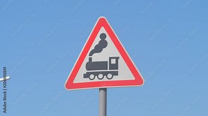 Railroad Level Crossing Sign without barrier or gate ahead the road, beware of train roadside steam engine locomotive signage road sign on signpost pole. Train sign railroad ahead.