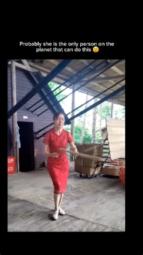 Fact_verse__ on Instagram: "The video depicts a woman in a red dress expertly manipulating devil sticks—two handheld sticks used to control a longer central stick through spins, tosses, and catches—in a warehouse setting, showcasing fluid, synchronized patterns that highlight precise hand-eye coordination. , a account sharing viral media, the clip amassed 78,000 likes and 5.5 million views in days, with replies debating its uniqueness: some hail it as superhuman, while others recognize it as a c