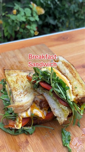 Delicious Breakfast Sandwich Recipe with Arugula, Tomatoes, Eggs, Cheese, and Pesto