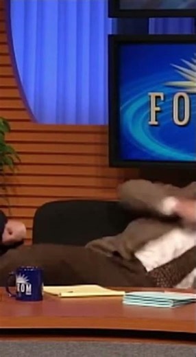 Aggressive Cat jumped on the anchor's head during a live broadcast