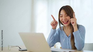 Young asian woman working at home. Female using computer laptop on desk at house