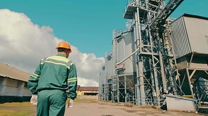 Engineer inspecting grain storage elevators. An employee of an agricultural company inspects elevator installations. Storage of grain crops