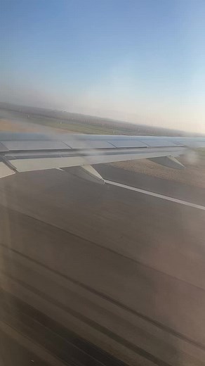 Airplane Wing View During Landing Over Beautiful Landscape